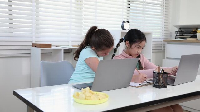 Education learning homeschool technology concept shows modern study desk with laptops prepared in bright home classroom, supporting digital education, smart study environment, private tutor activities