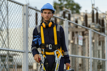 Fototapeta premium Electrical technicians are inspecting the operation and power distribution system within the substation that receives energy from the wind farm.