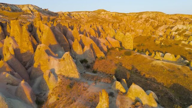 Goreme, Nevsehir, Turkey. Magical evening view of Devrent Valley with enchanting rock sculptures and warm sunset illumination.. Aerial View