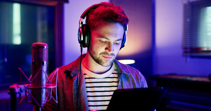 Man, neon and broadcaster with mic on tablet for radio podcast or recording in production studio. Male person, announcer or journalist working late with technology or headphones for audio news on air