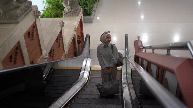 Muslim Woman Riding Escalator in Airport Terminal Travel Lifestyle