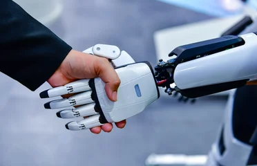 Robot and human handshake representing artificial intelligence collaboration and future technology. © I Viewfinder