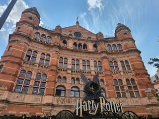 Naklejka premium London, UK 03.07.2025 grand historic theater building facade with Harry Potter and the Cursed Child signage and iconic nest sculpture in London cultural district