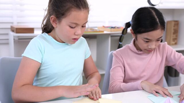 Modern young students online learning content creator, elementary girls explain homework to teacher record paper activity by phone, digital education, creativity vlog, alpha generation study lifestyle