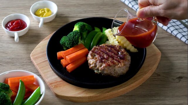Hot Plate Hamburg Steak on a wooden table.