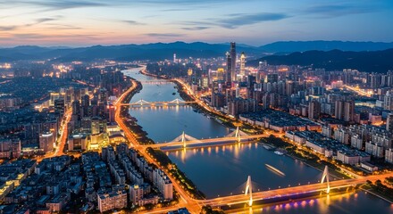 Obraz premium Cityscape at Dusk: Illuminated Bridges and Skyscrapers over River, Aerial View