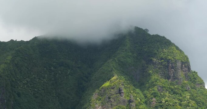 Peak of Mount Rotui covered by clouds, view from Opunohu Bay, island of Moorea, French Polynesia.