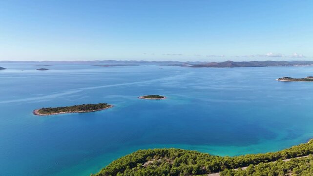 Wide October drone panorama over the blue Adriatic and islands near Pako&scaron;tane, slowly turning to reveal Drage marina, the village, Vrana Lake, and the coastline back toward Pako&scaron;tane.
