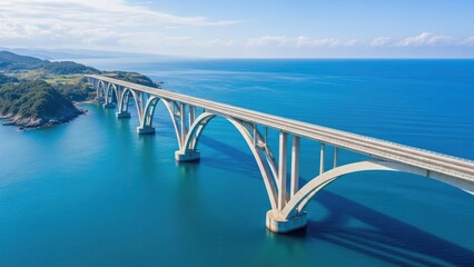 Naklejka premium A long white bridge spans across a vast blue ocean under a clear sky