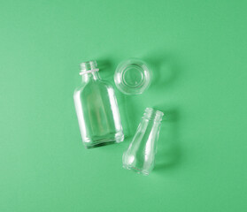 Glass waste on green background, recycling concept. Concept of eco friendly waste sorting, environmental protection, and sustainable living.