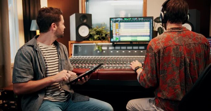 Production, tablet and producers in studio with music for working on album or song with computer. DJ, equipment and male sound technicians with technology for mixing audio track in recording booth.