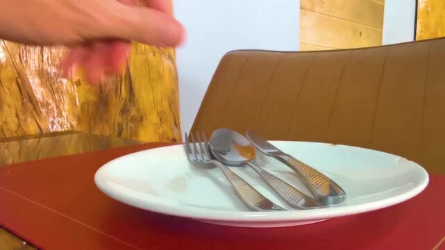 Premium restaurant table setup with empty plate fork knife spoon.