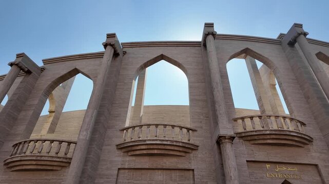 Katara cultural village amphitheater facade low angle cinematic motion footage with arches.