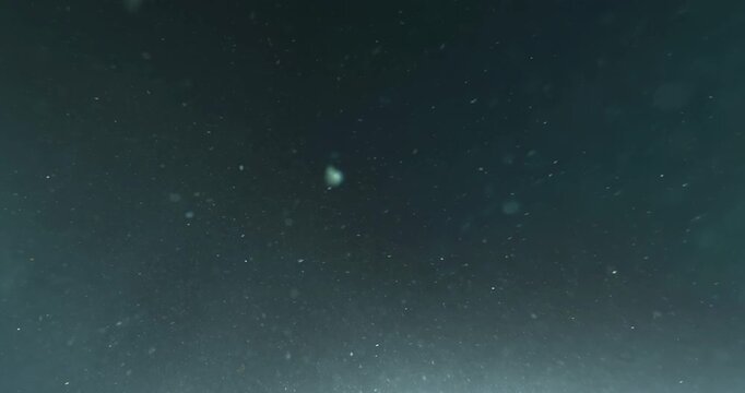 Cinematic 4K underwater footage captured from the POV of a deep-sea ROV drone, drifting through a vast, atmospheric water column filled with floating particles, soft light rays, and immersive depth&mdash;pe