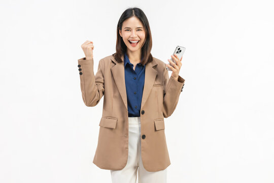 Smiling young Asian businesswoman using smartphone and pointing at mobile screen on white studio background.
