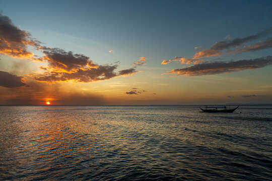 Beautiful sunset at Aniloa Phlippines with clam waters