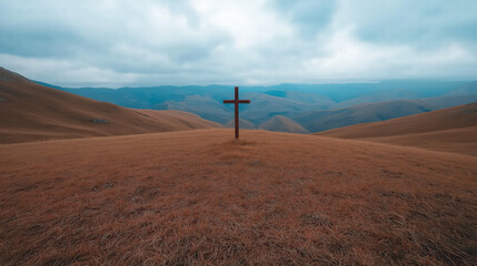 Obraz premium Cross standing alone at the top of a hill at night, dramatic dark sky, quiet and solemn biblical atmosphere, powerful symbol of faith and sacrifice