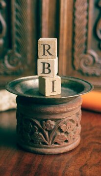 Defocused scene showing RBI letters on wooden cubes representing central banking theme