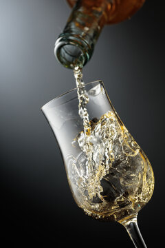 Whiskey is poured from a bottle into a glass.