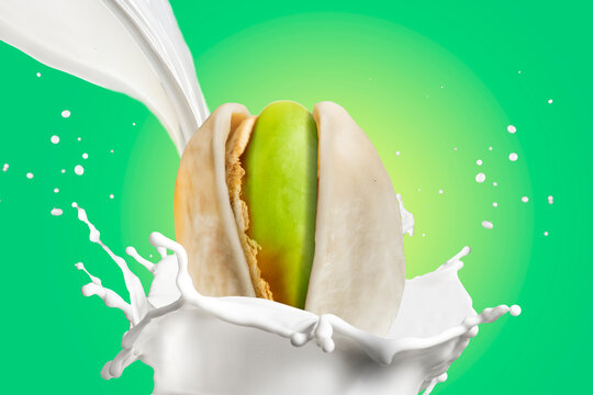 Pistachio Nuts Splashing in Milk on White Background. Great for advertising pistachio products, plant-based milk, healthy snacks, dairy or nut-based beverages, ice cream and dessert branding,