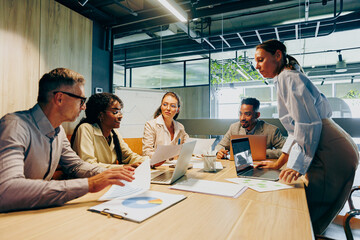 Team engaged in lively discussion analyzing data and planning ahead