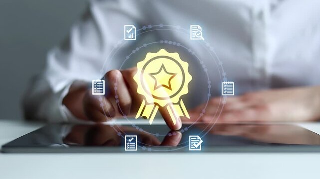 Hands writing on a tablet with icons showing documents and a medal in a workspace setting during the day.