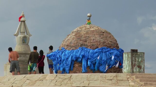  Mongolia, Sainshand - july 29, 2015: Buddhist architectural complex Shambhala in the Gobi desert. Tourists near the main Shrine. Summer cloudy day.
