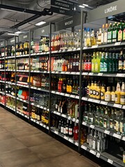 Fototapeta premium Supermarket Liquor Aisle with Variety of alcohol Bottles on Shelves