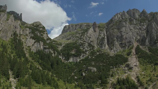 Majestic ascending drone view toward the main glacial cirque of Valea Gaura in the Bucegi Mountains, Romanian Carpathians, cinematic continuous moving shot