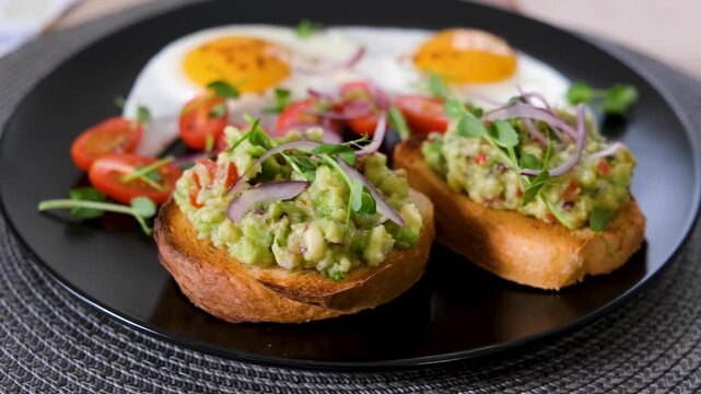 Looping food video with rotating plate of eggs and avocado toast