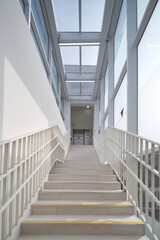 Obraz premium Stair bridge in glass atrium with skylight above contemporary building