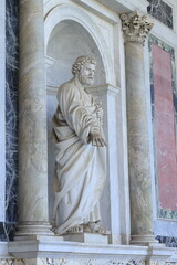 Fototapeta premium Statue of Saint Peter Standing in a Niche Between Two Columns on the Facade of the San Paolo Fuori le Mura Basilica in Rome, Italy
