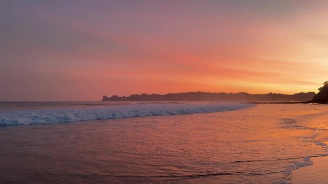 Scenic coastal landscape at sunset with waves breaking on a sandy shore, dramatic sky colors, capturing a tranquil vacation mood. located at Sendiki beach East Java, Indonesia
