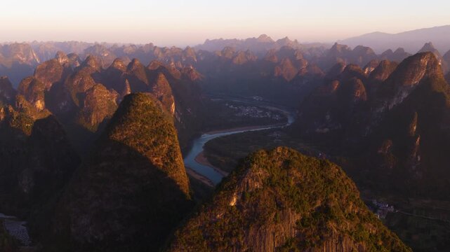 Li River Winding Through The Dramatic Karst Limestone Mountains Of Guangxi Province, China. Aerial Drone Shot