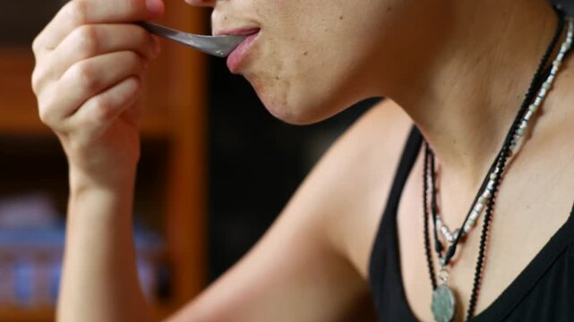 Middle-aged women chews food, close-up
