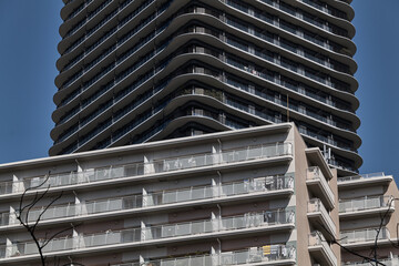 Layered apartment towers and curving balcony patterns in close view © Namsun