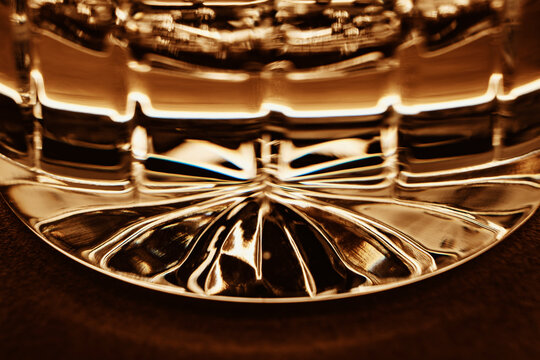 Abstract close up of glass detail with warm tones and reflections