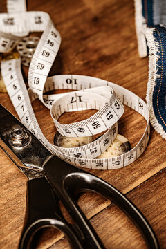 Sewing accessories and tools with fabric and scissors on wooden table