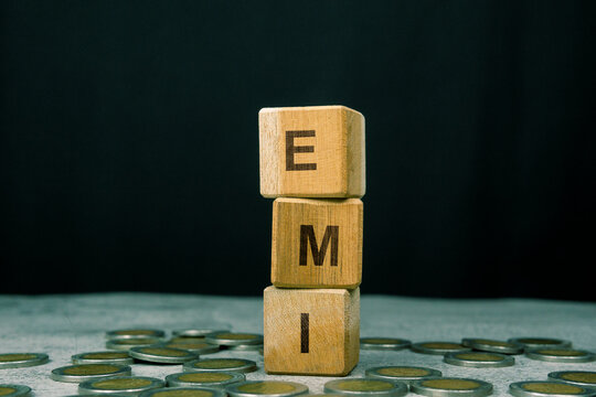 EMI word on a stack of wooden cubes. Financial Investment Concept