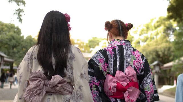 Two Women in Traditional Kimonos Walking Through Meiji Jingu Shrine