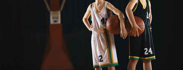 Basketball Players Holding Ball. Young Athletes Standing on Indoor Court During Game or Training