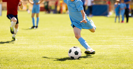 Youth Soccer Game Action. Kid Dribbling Ball on Grass Field During Football Match