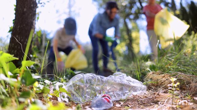 Volunteers collecting plastic waste and cleaning up a polluted forest while collaborating to preserve the environment and fight for a cleaner planet for future generations	
