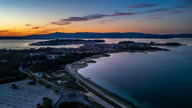 Aerial sunset view of Illa de Arousa with mussel rafts, Galicia