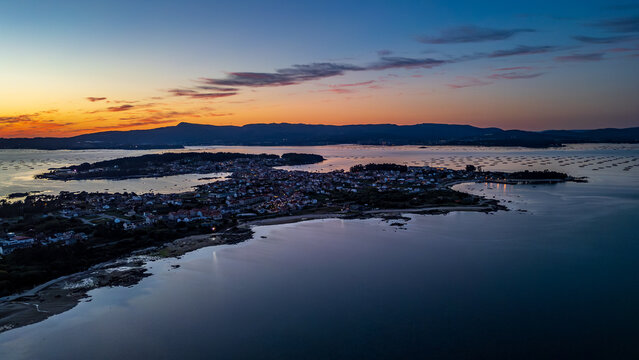 Aerial sunset view of Illa de Arousa with mussel rafts, Galicia