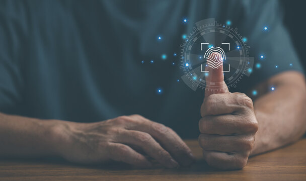 Businessman showing thumbs up with glowing digital security icons hologram, representing approval, cybersecurity, data protection, and trust in modern technology on dark background.