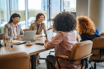 Fototapeta premium Diverse businesswomen collaborating during a corporate meeting in modern office
