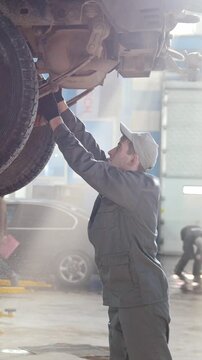Car automobile service - mechanic checks the luxury SUV