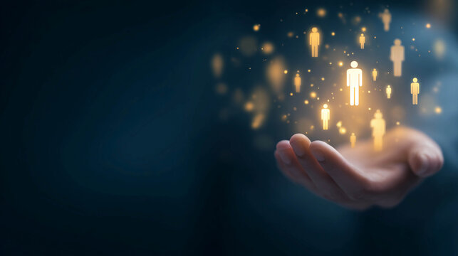 A human hand on a dark background, with glowing yellow icons of people floating above it, representing the concept of human resources management, customer base, leadership, and teamwork.