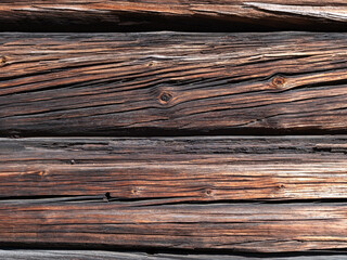 Fototapeta premium weathered old wooden log wall texture background outdoors
